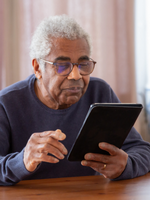 Older gentleman looking at ipad